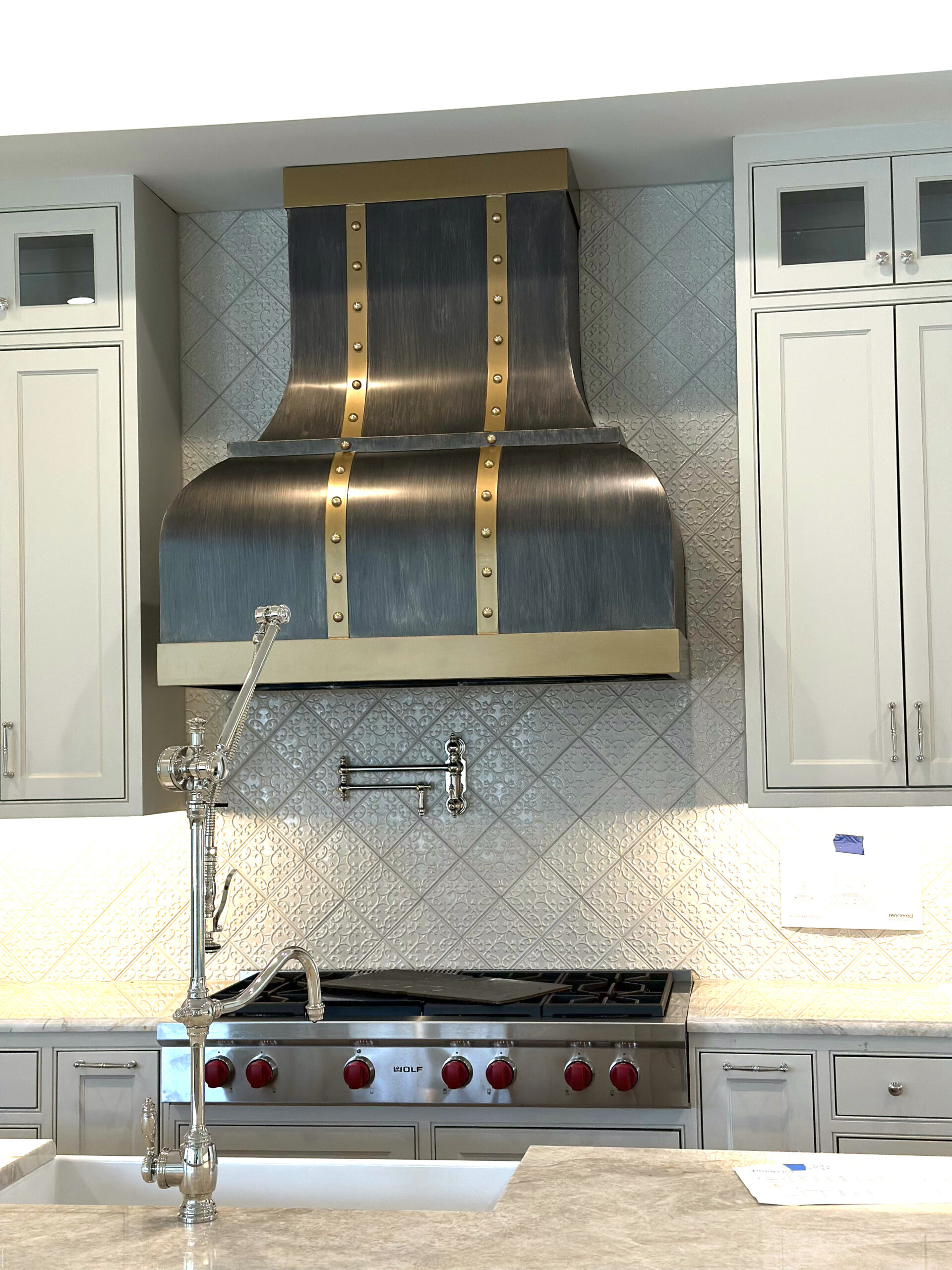 custom metal vent hood with brass trim