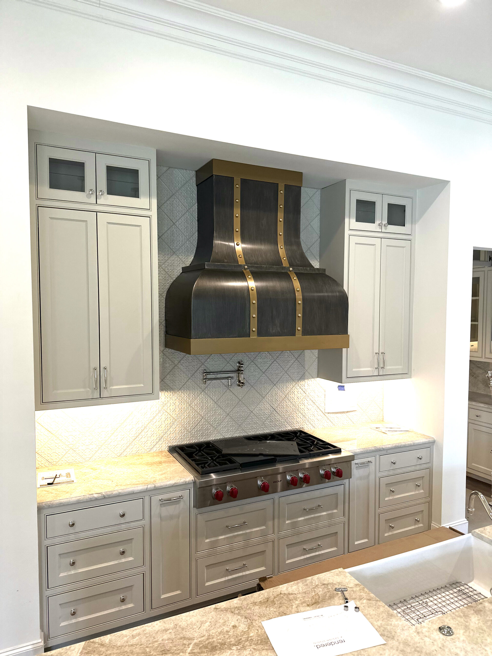 custom metal vent hood with brass trim